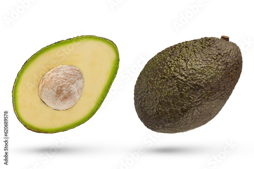 Fotografie Falling avocado divided into parts isolated on white background
