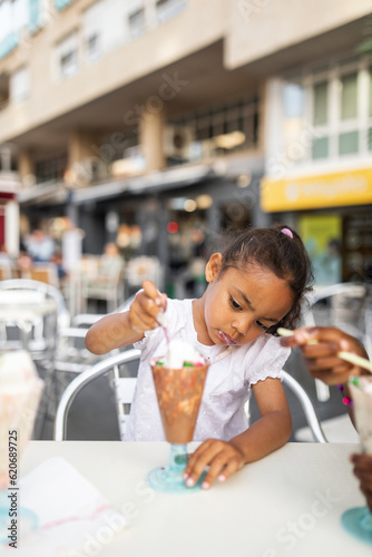 black girl eating ice cream outdoors in the city