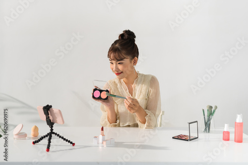  Influencer woman live streaming cosmetics product review photo