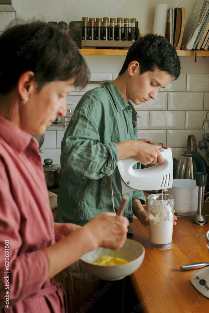 Women cooking together in stylish kitchen Women cooking together in stylish kitchen