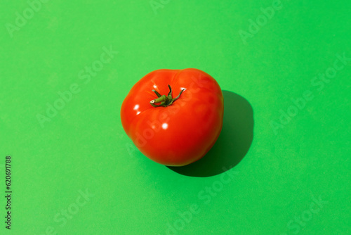Tomato on a colorful background with hard lighting