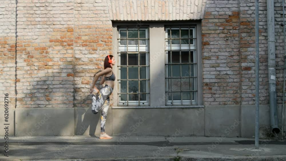 Young woman getting fit in downtown city street Young woman getting fit in downtown city street