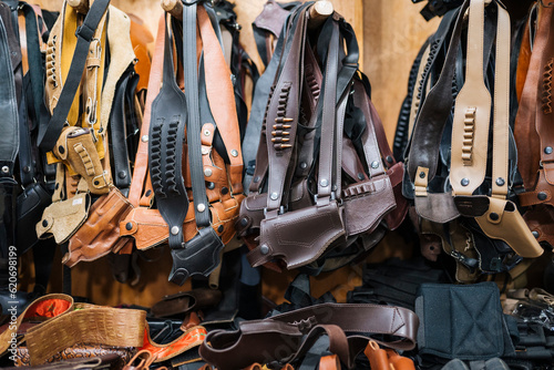 Leather holster belts in workshop photo
