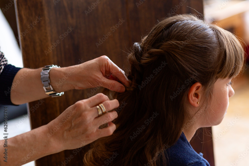 Hairdresser working on a girl's hair Hairdresser working on a girl's hair
