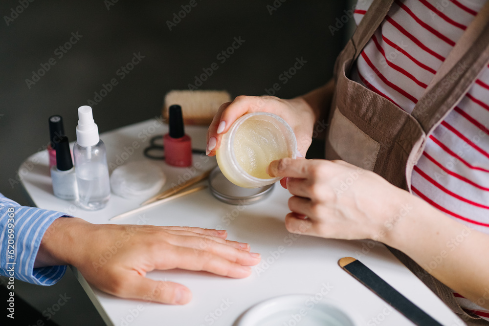 Female Manicurist Opening Bottle with Cream Female Manicurist Opening Bottle with Cream