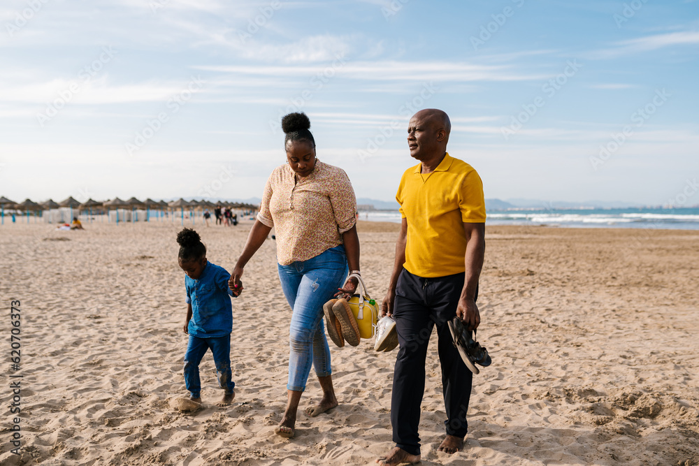 Black family walking on sandy beach Black family walking on sandy beach