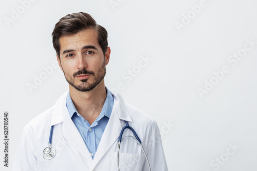 Man doctor in white coat with stethoscope and eyeglasses on white isolated background looking into camera, copy space, space for text, health