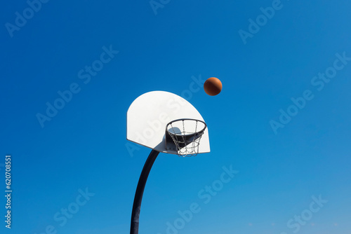 Basketball landing on the basket photo