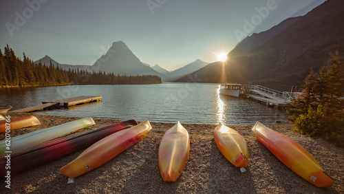 Two Medicine Lake beach and kayaks with golden, evening sunlight | Glacier National Park, Montana, USA photo