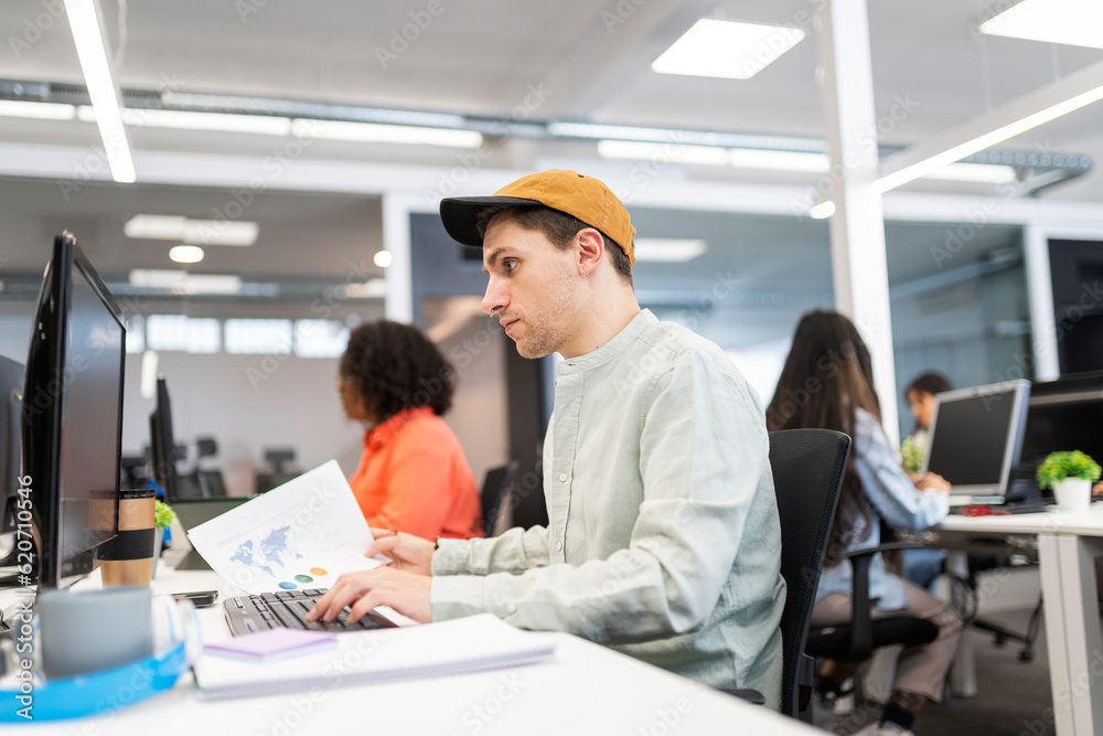 Focused young man Working In A Modern Office Focused young man Working In A Modern Office