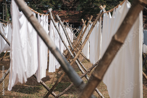 Rows of drying bed sheets. photo