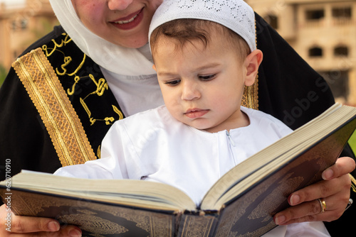 Mother Teaches Son to Read Quran on Eid photo