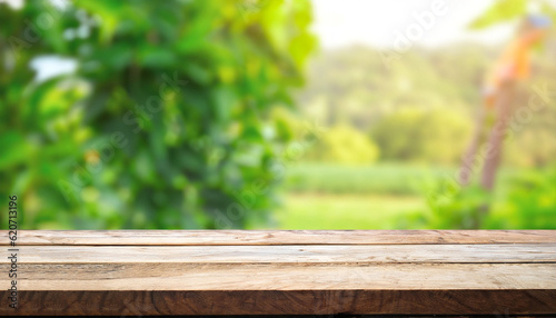 Wooden table top on blur plant vegetable or fruit organic farm background. For place food, drink or health care business. Fresh landscape and relax season concept. View of copy space.