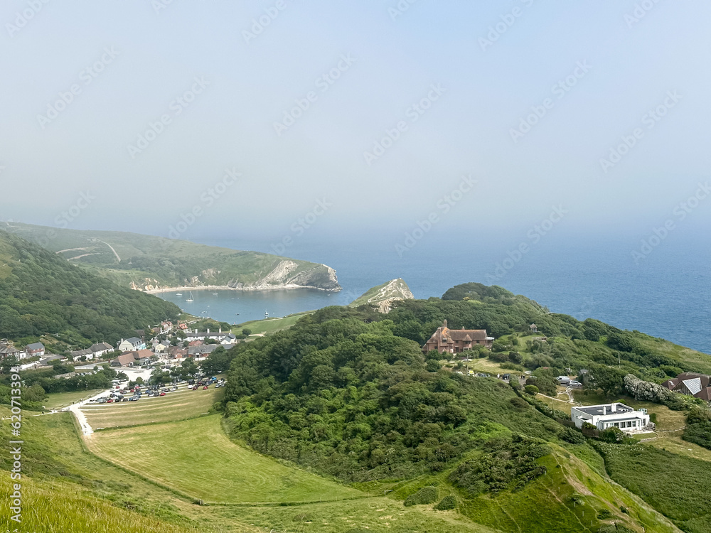 Lulworth Cove and beach view. Lulworth Cove bay, beach and cliffs view . The Jurassic Coast is a World Heritage Site on the English Channel coast of southern England. Dorset, UK. crowded beach, public