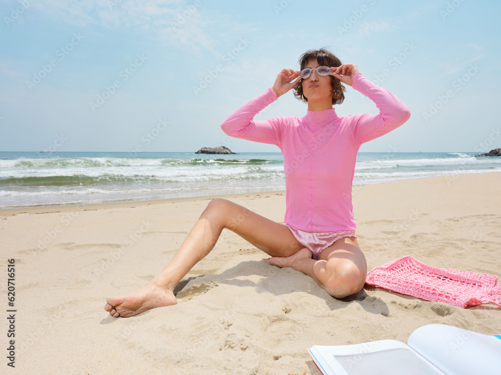 Woman in pink On Summer Beach Vacation in swimming goggles Woman in pink On Summer Beach Vacation in swimming goggles