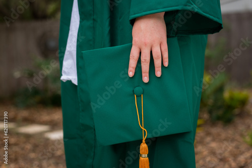 Student hand holding graduation cap photo