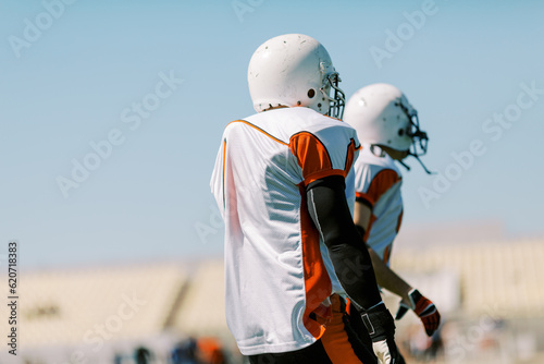 Athletes With White Helmets and uniforms
 photo