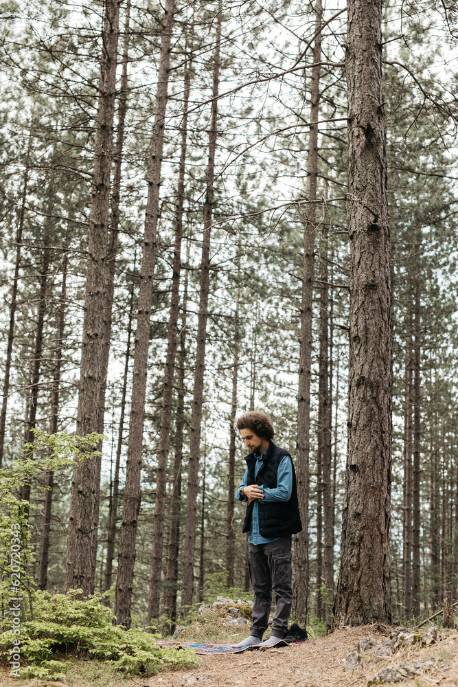 man standing in a forest man standing in a forest