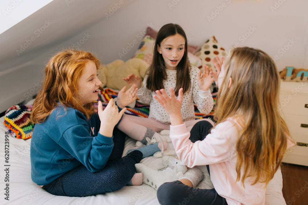 Girls playing Patty Cake Girls playing Patty Cake