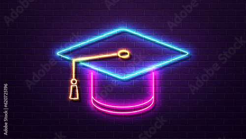 3d neon academic hat in pink blue and yellow on a brick wall background. photo