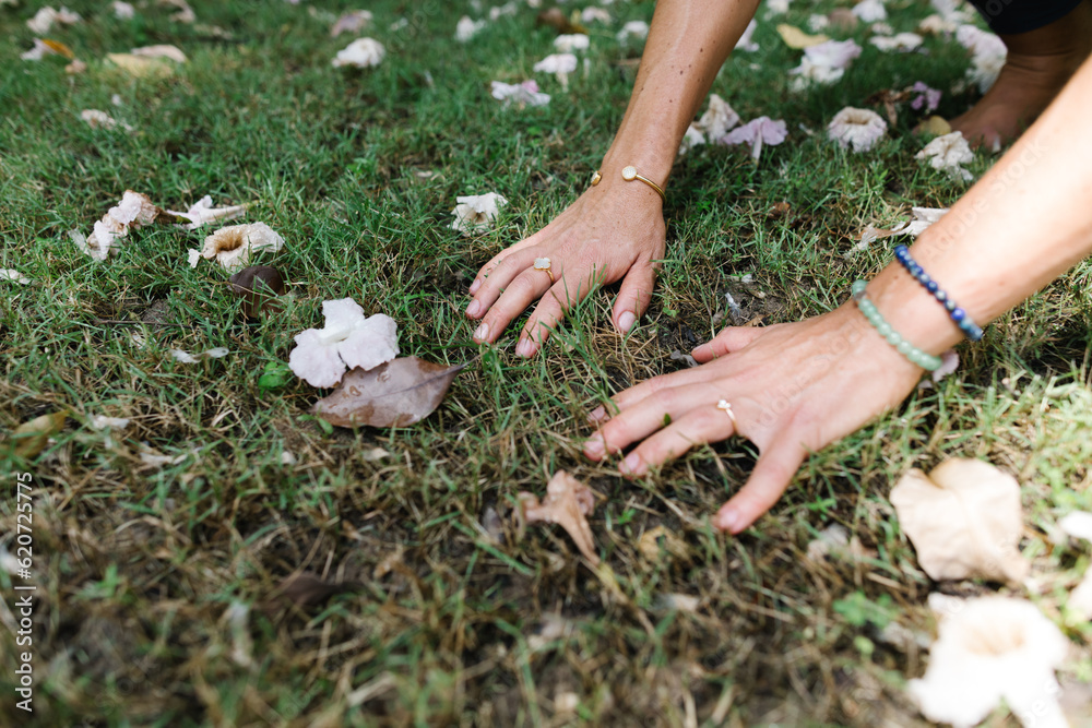 Woman touching the ground with her hands Woman touching the ground with her hands