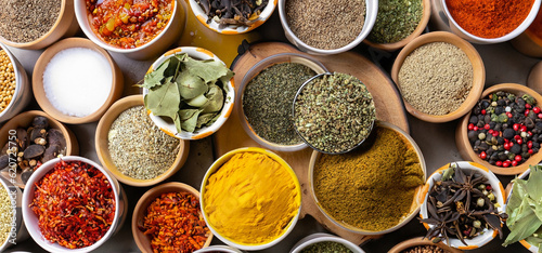 Fresh spices and herbs for food. Colorful condiments as background  top view. lot seasonings in cups  on table
