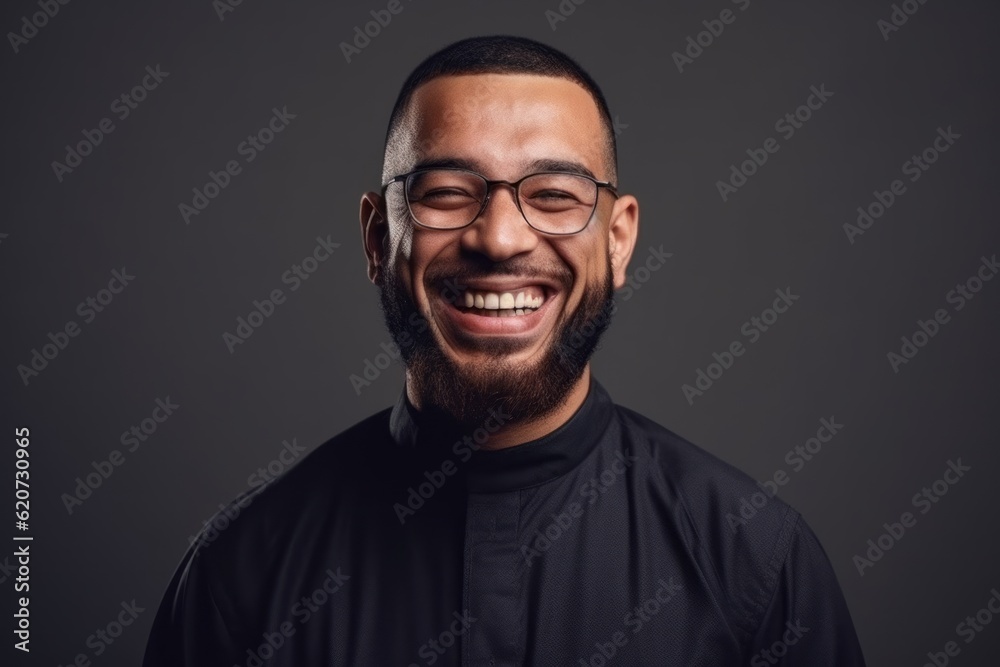 Portrait of a happy young man in eyeglasses on a dark background