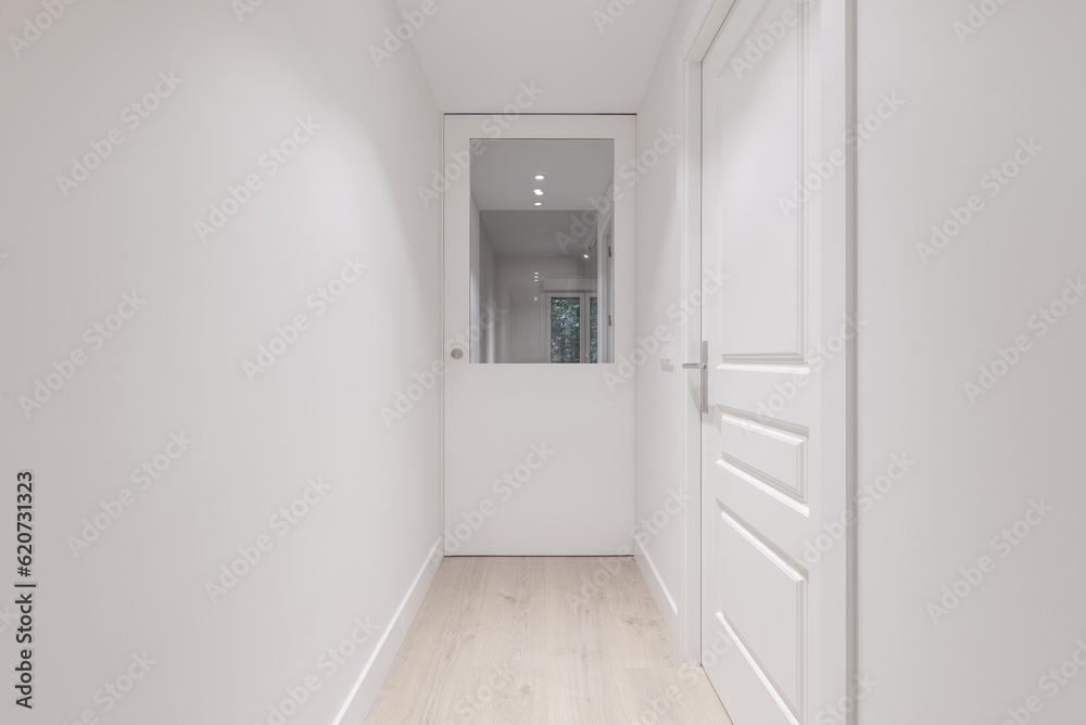 Corridor of a house with smooth white painted walls Corridor of a house with smooth white painted walls