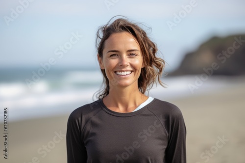Front view of a beautiful young woman smiling at the camera on the beach © Eber Braun