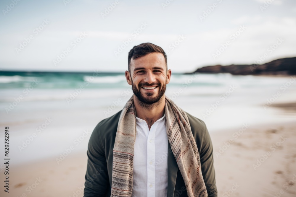 Portrait of a handsome young man standing on the beach and smiling Portrait of a handsome young man standing on the beach and smiling