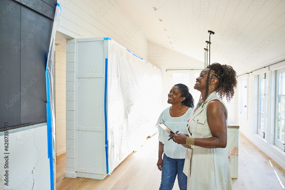© Trinette Reed/Stocksy - Black real estate agent showing a new construction home to client