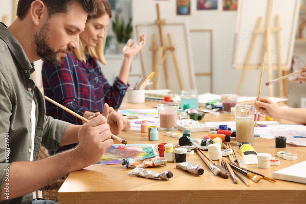 Fototapeta premium Students attending painting class in studio. Creative hobby
