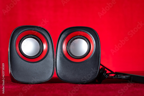 small speakers for laptop on red