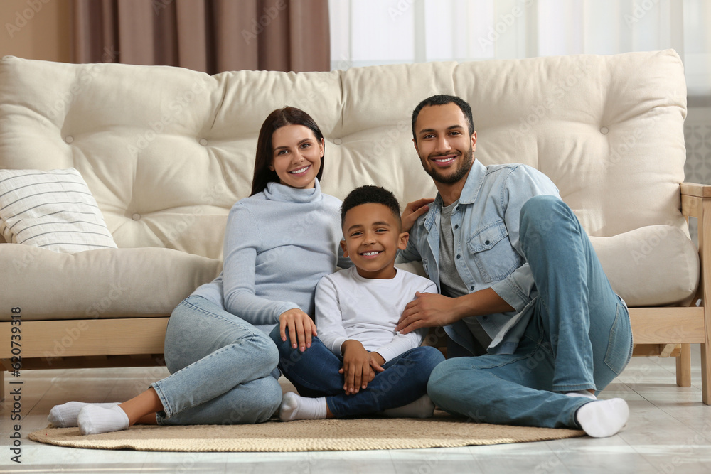 Happy international family sitting on floor at home Happy international family sitting on floor at home