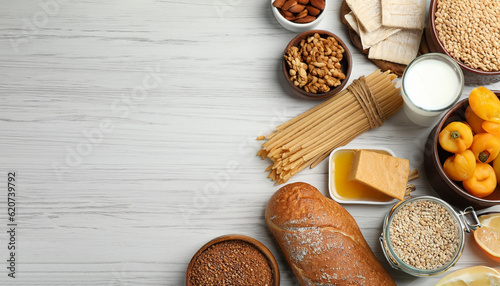 Different gluten free products on white wooden table, flat lay. Space for text