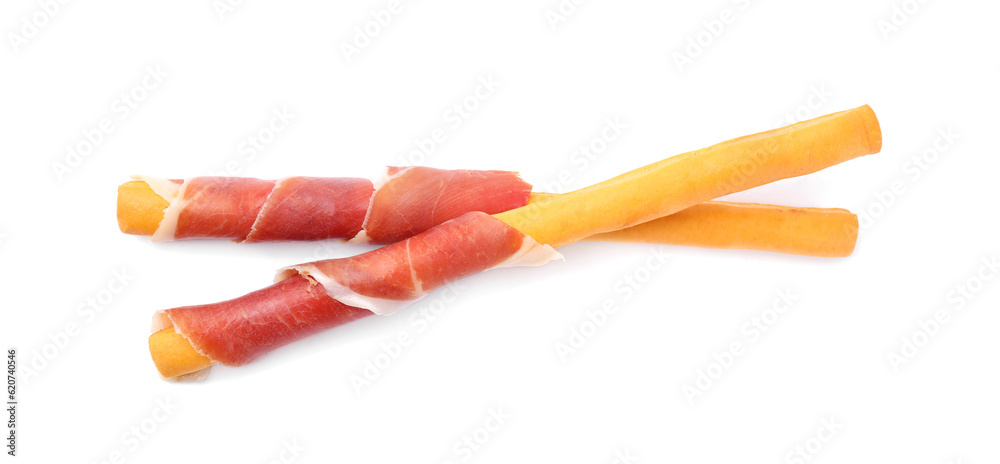 Delicious grissini sticks with prosciutto on white background, top view Delicious grissini sticks with prosciutto on white background, top view
