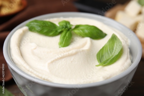 Delicious tofu sauce and basil leaves in bowl, closeup