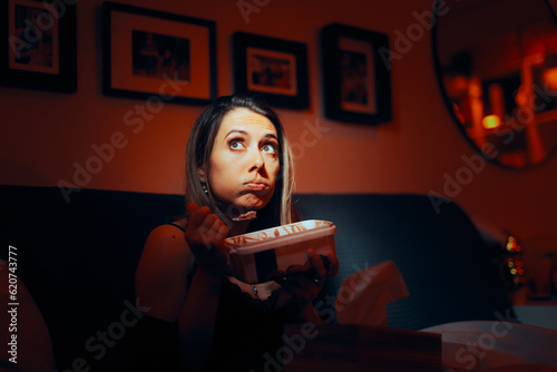 Stressed Woman Eating Ice-Cream at Night. Unhappy woman eating her feelings looking for comfort in sweet food 