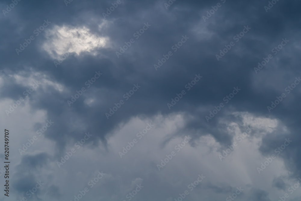 Obraz premium The process of formation and intensification of cumulus storm clouds. The concept of nature, clouds, movement, wind, weather, and changes occurring with them at the moment daily and around the world