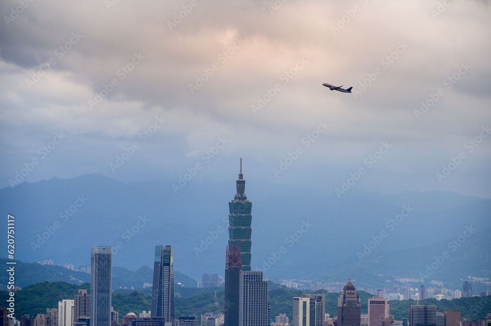 The plane is over the city. Dramatic cloudscape in cloudy city sky. Overlooking the urban landscape from Neihu Bishanyan. Taipei, Taiwan