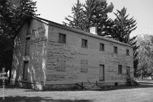 Black and white old wooden building with closed windows and doors