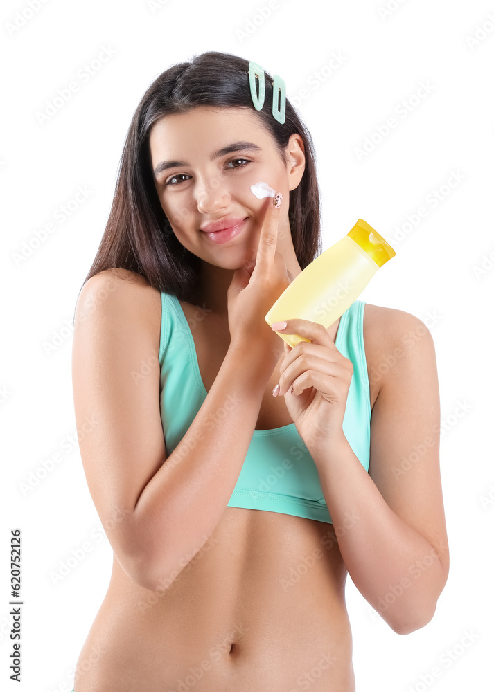 Beautiful young woman applying sunscreen cream on white background Beautiful young woman applying sunscreen cream on white background