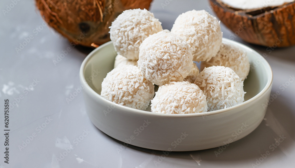 Coconut balls, raw and healthy sugar free rafaello candies. Vegetarian energy sweets recipe step by step. Round tasty dessert in ceramic bowl. Copy space, close up view. Healthy organic food for kids. Coconut balls, raw and healthy sugar free rafaello candies. Vegetarian energy sweets recipe step by step. Round tasty dessert in ceramic bowl. Copy space, close up view. Healthy organic food for kids.