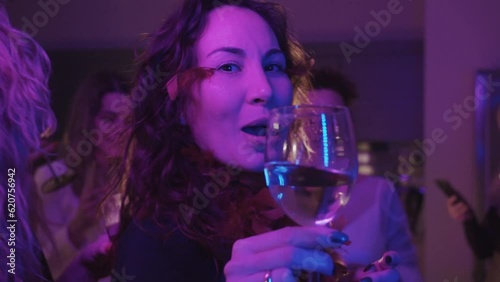 Woman with bright feather makeup have fun at party photo