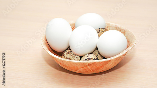 Chicken eggs and quail on a breakfast plate