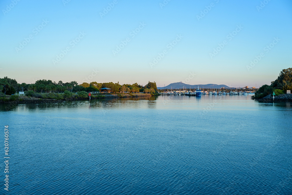 Fototapeta premium sea level view of Gladstone marina with Mount Larcom in the distance, Queensland, Australia