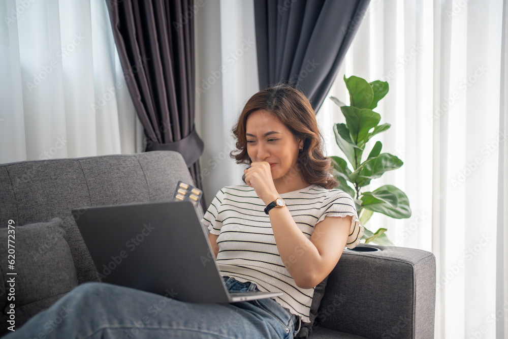Asian woman is sick and talking to doctor via video call about sickness and medicine on laptop computer at home. Asian woman is sick and talking to doctor via video call about sickness and medicine on laptop computer at home.