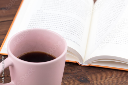 A cup of coffee and an open book