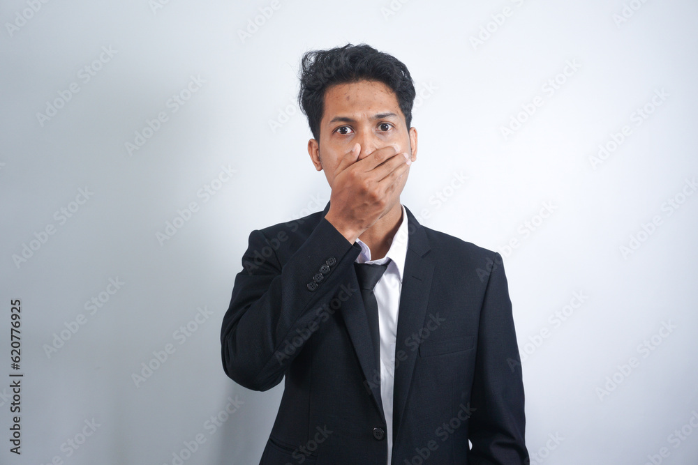 Young handsome Asian man wearing suit standing over isolated white background shocked covering mouth with hands for mistake. Secret concept. Young handsome Asian man wearing suit standing over isolated white background shocked covering mouth with hands for mistake. Secret concept.