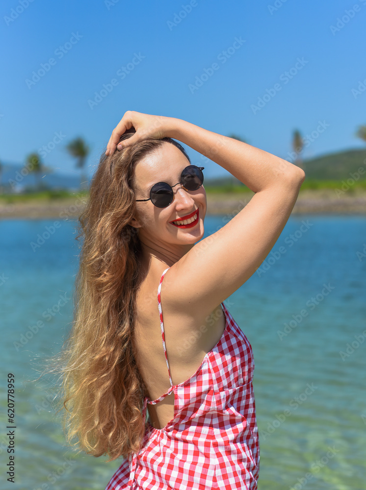 Naklejka premium Bright blond young woman standing in sea in summe